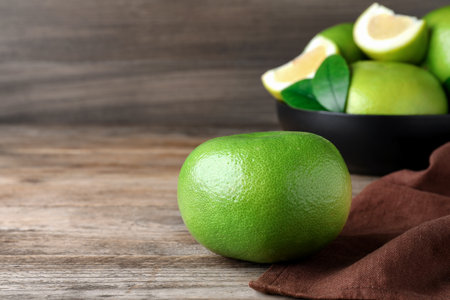 Fresh ripe sweetie fruit on wooden table, space for textの写真素材