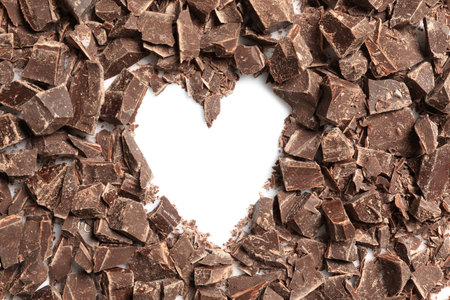 Heart made with dark chocolate crumbles on white background, top viewの写真素材