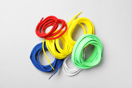 Colorful shoelaces on light background, flat layの写真素材