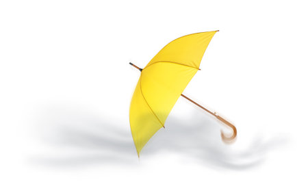 Open umbrella blown by wind gust on white backgroundの写真素材