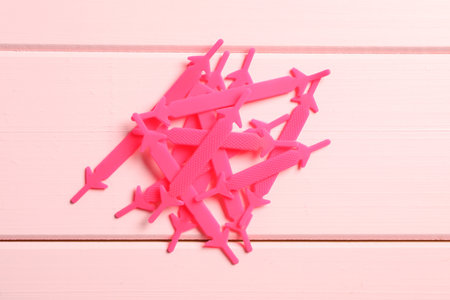Silicone shoelaces on pink wooden background, flat layの写真素材