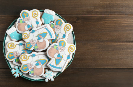 Tasty gingerbread cookies on wooden table, top view with space for text. St. Nicholas Day celebrationの写真素材