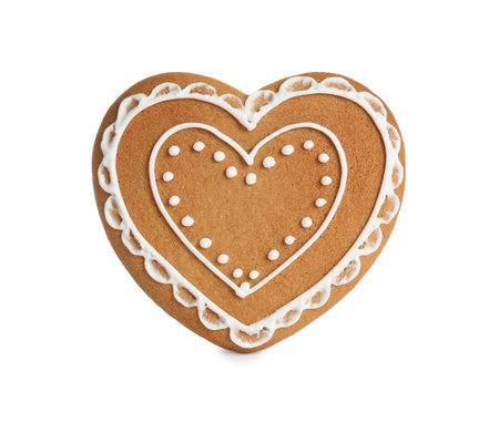 Gingerbread heart decorated with icing isolated on whiteの写真素材