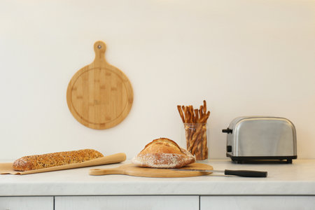 Loaves of bread and grissini on the counter in the kitchenの写真素材