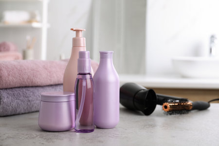 Different hair care products on table in bathroom, space for textの写真素材
