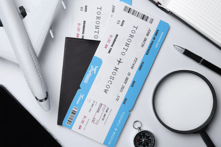 Flat lay composition with air tickets and passports on white background. travel agency conceptの写真素材