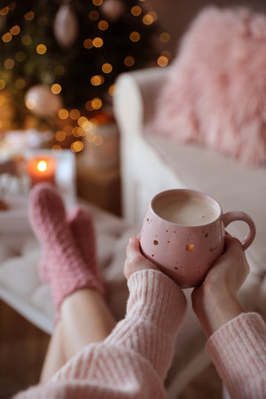 Woman holding cup of cocoa at home, closeup. christmas moodの写真素材