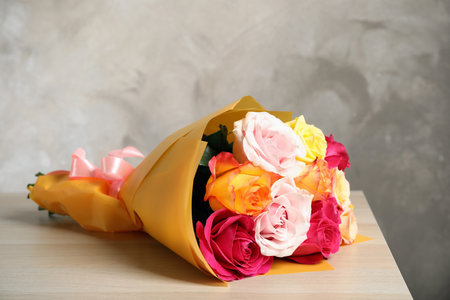 Luxury bouquet of fresh roses on wooden tableの写真素材