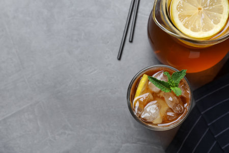 Delicious iced tea on gray table, flat lay. Space for textの写真素材