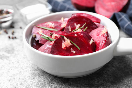 Raw beetroot slices, garlic and rosemary on gray table, closeupの写真素材