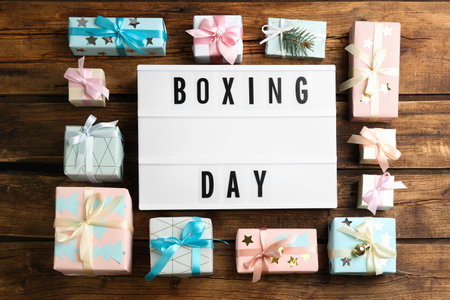Lightbox with phrase BOXING DAY and Christmas decorations on wooden background, flat layの写真素材