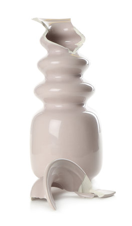 Broken pink ceramic vase isolated on whiteの写真素材