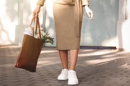 Woman with leather shopper bag outdoors, closeupの写真素材