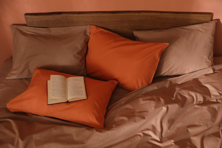 Book on bed with brown and orange linesの写真素材