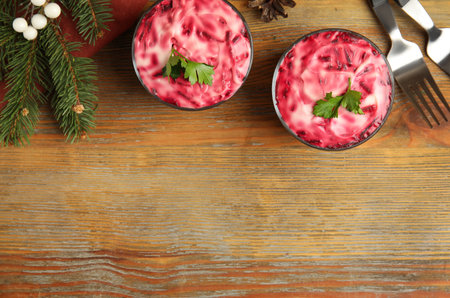 Herring under fur coat served on wooden table, flat lay with space for text. Russian traditional saladの写真素材