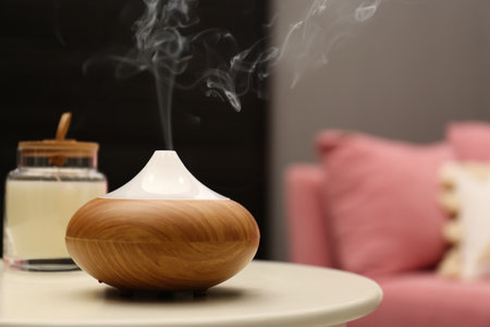 Aroma oil diffuser on table in room. Space for textの写真素材