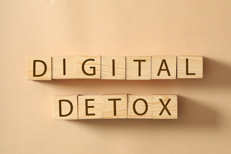 Wooden cubes with words DIGITAL DETOX on beige background, flat layの写真素材