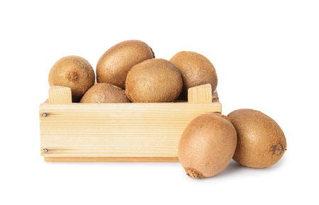 Whole fresh kiwis in wooden crate on white backgroundの写真素材