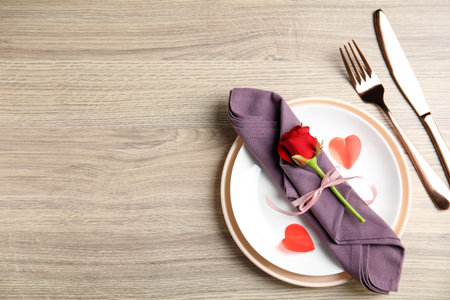 Beautiful place setting on wooden table, flat lay with space for text. Valentine's day romantic dinnerの写真素材