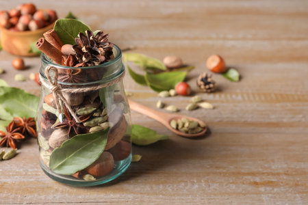 Aromatic potpourri in glass jar on wooden table. Space for textの写真素材