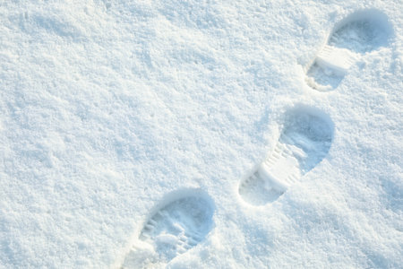 Footprints on white snow outdoors, above view. winter seasonの写真素材