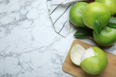 Fresh ripe sweetie fruits on white marble table, flat lay. Space for textの写真素材