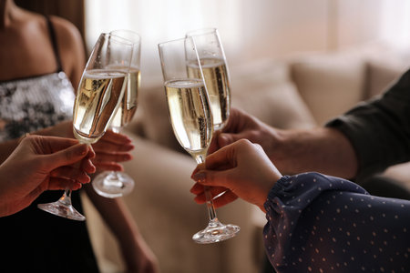 People clinking glasses with champagne at home, closeupの写真素材