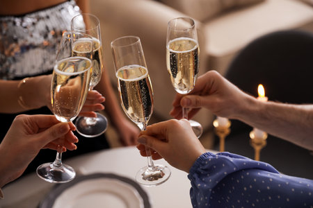 People clinking glasses with champagne at home, closeupの写真素材