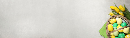 Flat lay composition with colorful Easter eggs and tulips on gray background, space for text. horizontal banner designの写真素材