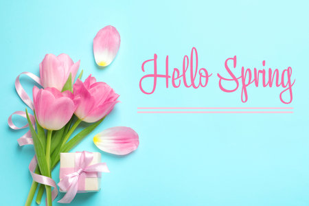 hello spring. Flat lay composition with beautiful tulips on light blue background