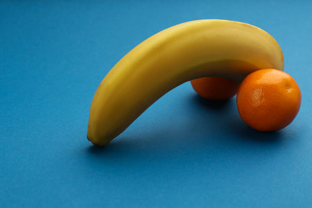 Fruits symbolizing male sexual organ on blue background. Potency problemの写真素材