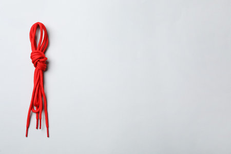 Red shoelaces on light background, top view. Space for textの写真素材