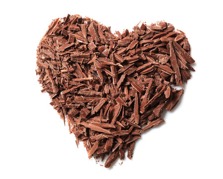 Heart made with milk chocolate crumbles on white background, top viewの写真素材