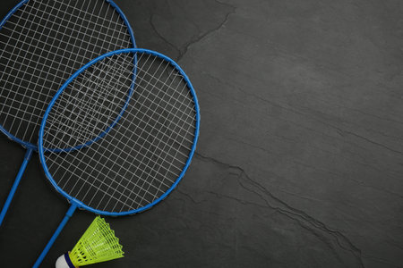 Rackets and shuttlecock on black background, flat lay with space for text. badminton equipmentの写真素材