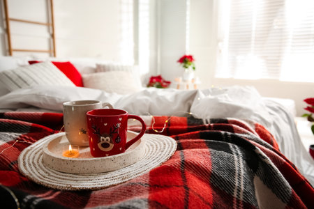 Christmas cups in tray on red woolen blanket. bedroom interiorの写真素材