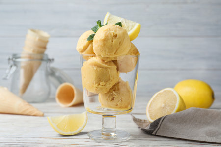 Yummy lemon ice cream served on white wooden tableの写真素材