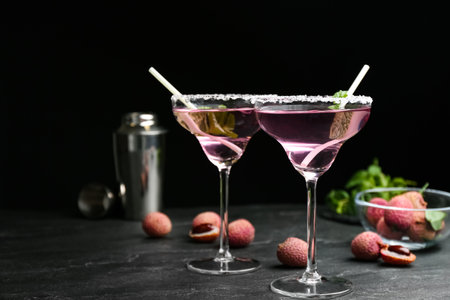 Delicious lychee cocktails and fresh fruits on black table. Space for textの写真素材