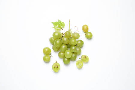 Bunch of fresh ripe green grapes with leaf on white background, top viewの写真素材