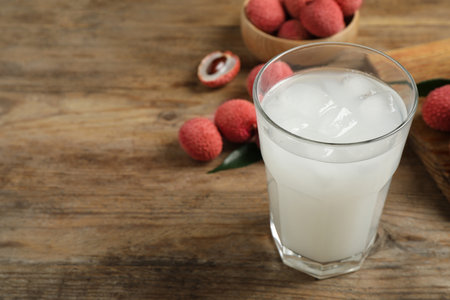 Fresh lychee juice on wooden table. Space for textの写真素材