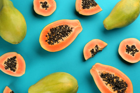 Fresh ripe papaya fruits on blue background, flat layの写真素材