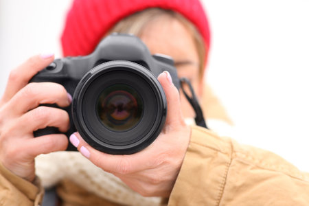 Photographer taking photo outdoors, focus on cameraの写真素材