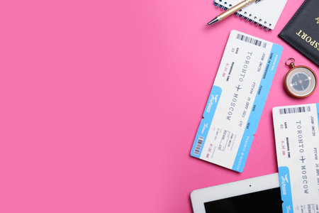 Flat lay composition with tickets on pink background, space for text. travel agency conceptの写真素材