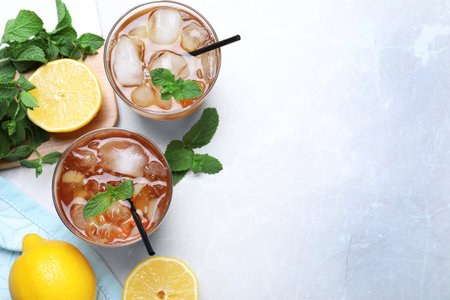 Delicious iced tea on light table, flat lay. Space for textの写真素材