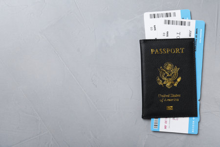 Passport with tickets on gray background, top view and space for text. travel agency conceptの写真素材