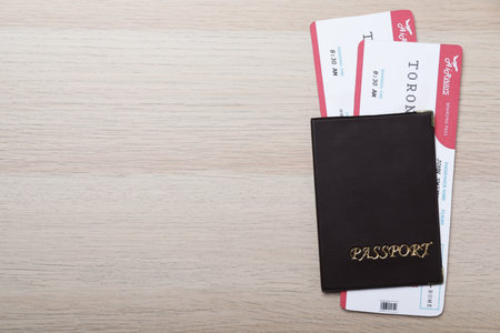 Avia tickets and passports on wooden table, flat lay with space for text. travel agency conceptの写真素材