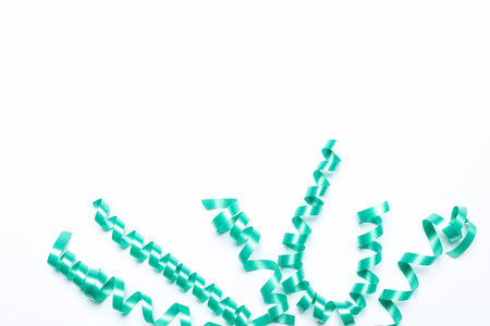 Turquoise serpentine streamers on white background, top viewの写真素材