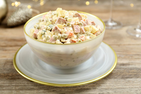 Traditional russian salad Olivier served on wooden tableの写真素材