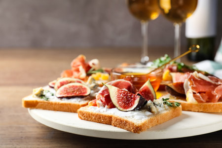 Sandwiches with figs, proscuitto and cheese on wooden table, closeupの写真素材