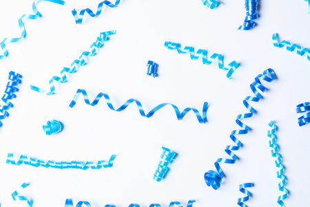 Blue serpentine streamers on white background, top viewの写真素材