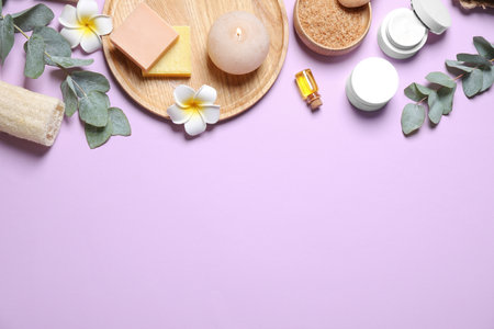 Flat lay composition with salt and cosmetic products on purple background. Space for textの写真素材